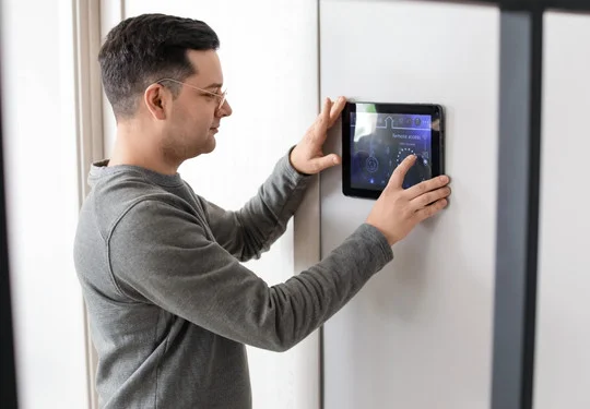 A man uses a tablet to manage an access control system
