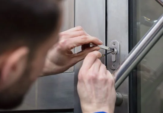 A technician unlocks a door